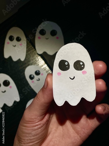 Hand Holding Cute Paper Ghost Character For Halloween DIY Decoration Close Up