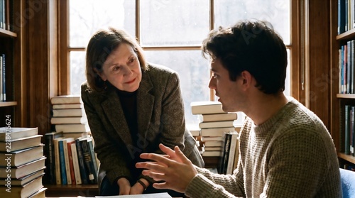 Female Professor Listening to College Student in Library