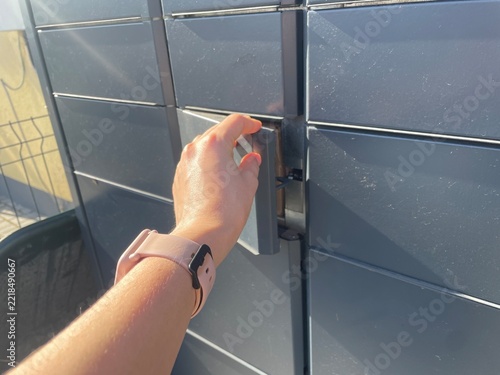 Woman Hand Opening Modern Automated Parcel Locker Door To Collect Package Outdoor