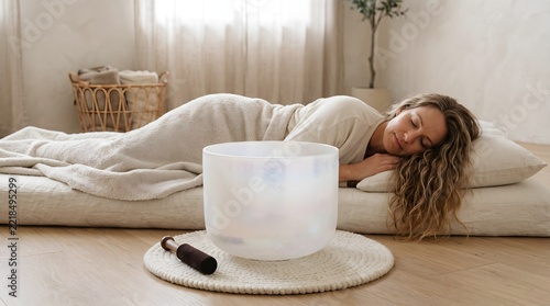 Relaxed Woman Sleeping During Sound Healing Therapy Session on Floor in Studio