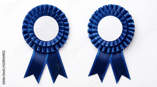 Two Blue Award Ribbon Rosettes with Blank Centers Isolated on White Background