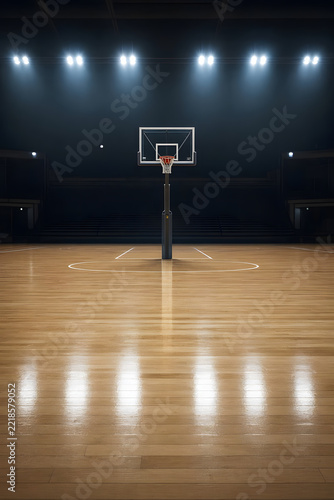 Empty basketball court with shiny wooden floor and white court lines