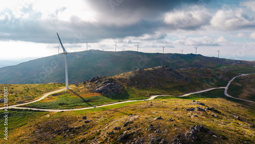 Wind turbines across rugged Portuguese mountain landscape