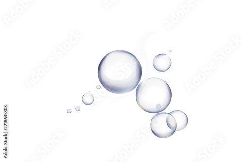 Macro of translucent liquid droplets and bubbles forming circular patterns with soft pink highlights and fluid streaks