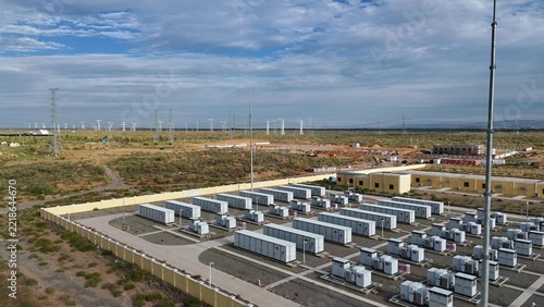 rows of energy storage battery containers in the desert landscape
