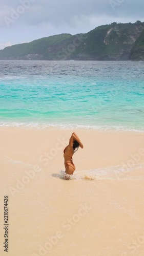 Woman in Bikini Dancing on Sandy Shore at Kelingking Beach Slow Motion