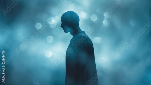 Silhouette of Man in Blue Foggy Atmosphere with Bokeh Lights