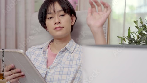 Beautiful Asian woman turns on PM 2.5 air purifier or adjust at home