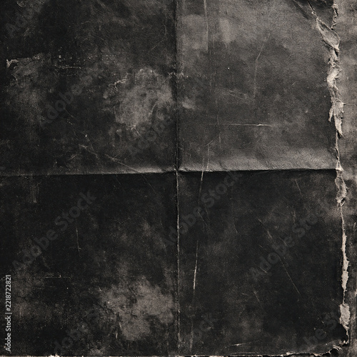 Dark grunge paper with fold creases and torn peeling edge on right
