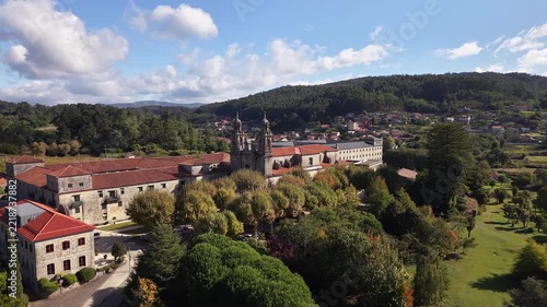 Historic poio monastery building standing among vineyards and green hills of galicia