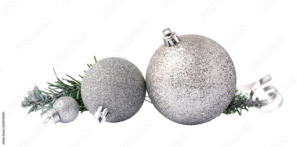 Fototapeta premium Decorative silver Christmas ornaments placed on a sprig of evergreen