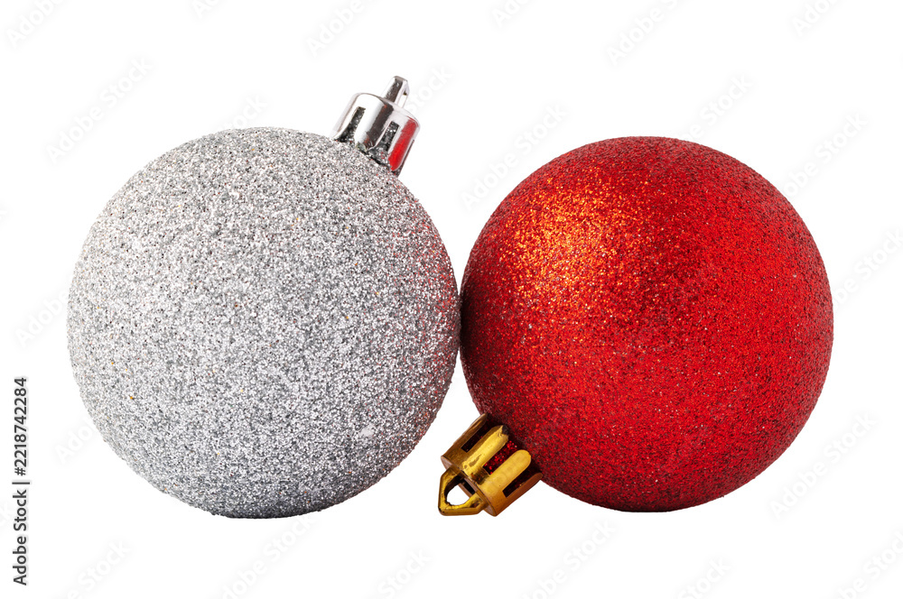 Fototapeta premium Two Christmas ornaments, one silver and one red, close together on a white background during the holiday season