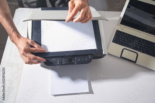 Fotografie Man copying and scanning documents in office.