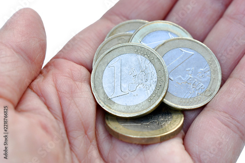1 Euro coins in hand. Woman hand holding 5 Euro money. Saving for future concept.