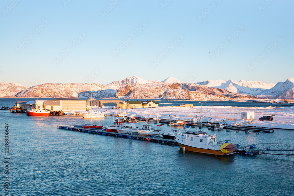 Fototapeta premium Beautiful winter landscape with red house (cabin) on the background sea sunset - Tromso, Norway