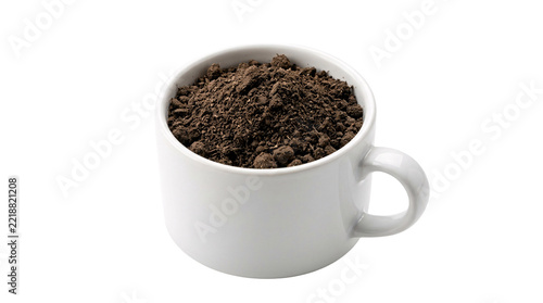 White ceramic mug filled with dark coffee grounds, isolated on a transparent background, ready for food and beverage concepts
