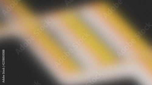 Abstract grainy gradient background with soft yellow and white glowing blurry shapes