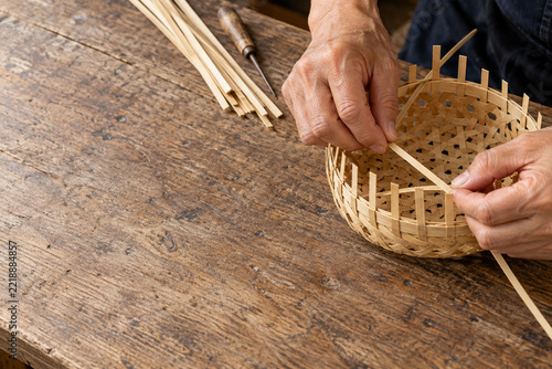Japanese artisan hands weaving traditional bamboo basket