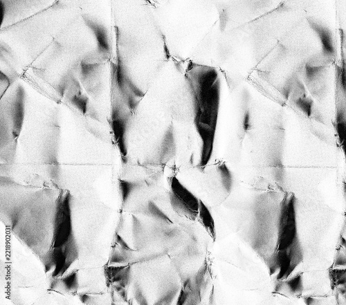Seamless black and white texture of crumpled paper with contrasting folds
