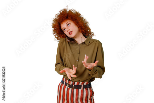 Fotografie Young woman with red curly hair talking on phone, expressing exasperation or annoyance with a hand gesture