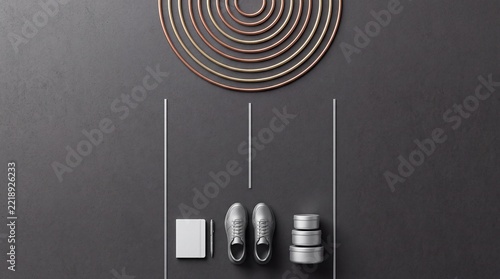 Top down overhead view of minimalist lifestyle essentials with generic sneakers, blank notebook, pen, and stacked tins on dark textured background with abstract concentric metallic rings