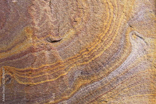 Details of the naturally occurring sandstone texture and color; colors and texture of the background sandstone