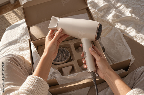 Woman Unboxing Hair Dryer at Home