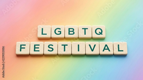 LGBTQ Estiva spelled out with letter tiles on a soft rainbow background