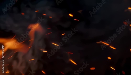 Glowing fire embers and bright sparks floating in dark air for video