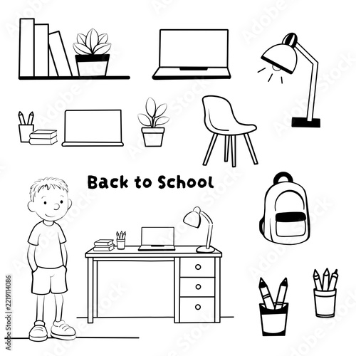 Boy stands by desk with school supplies and backpack for back to school theme