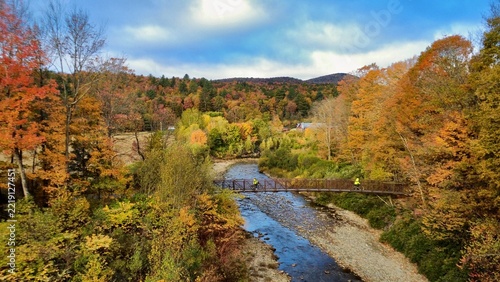 Bridge across river during peak fall foliage