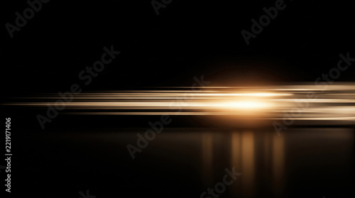Golden horizontal light streaks with motion blur and glowing flare on black background