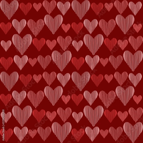 Seamless pattern of pink and cream striped hearts in different sizes on a deep red background
