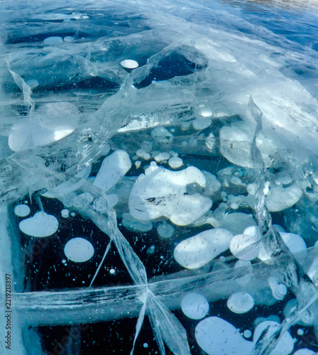 Obraz na plátně Close-up of frozen air bubbles inside the thickness of blue ice