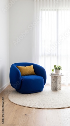 Cozy reading corner with cobalt blue swivel armchair, terrazzo side table and round jute rug