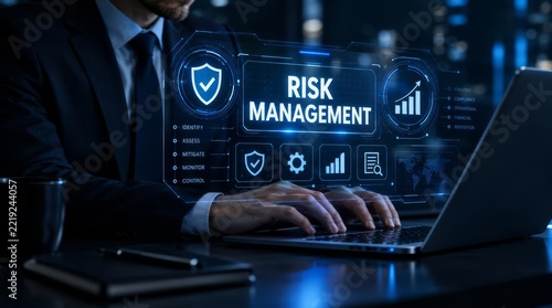 Businessman managing digital risk on laptop with holographic interface