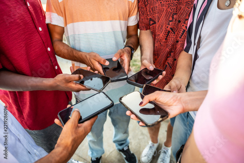 Diverse friends connecting online using mobile phones