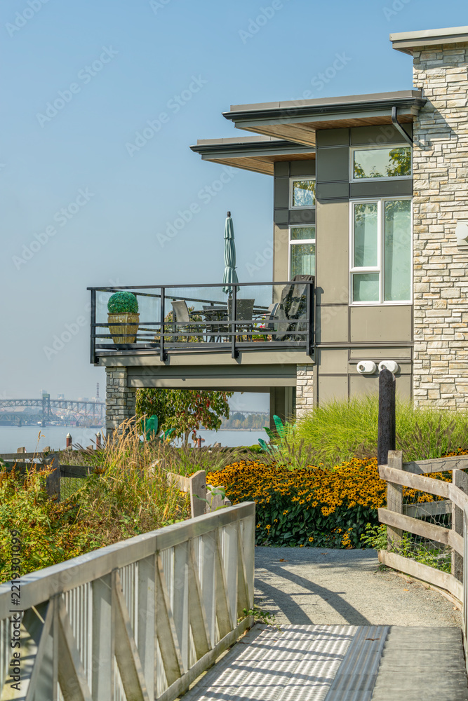 Fototapeta premium Waterfront Contemporary Home with Balcony, Garden and Walking Path