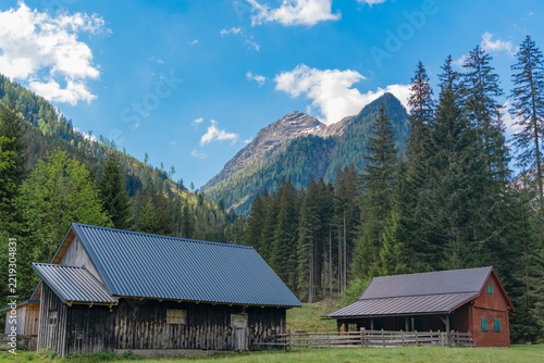 Travel to village in valley with cozy houses. Landscape and mountain rural scenery. Travel destination. Rural village houses. Landscape with mountain village in scenic nature