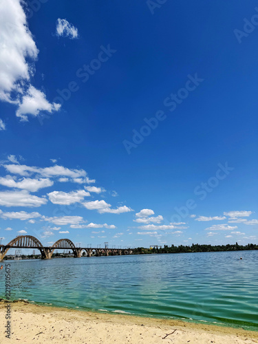 Stunning view on a Dnipro river in Dnipro, Ukraine, from the beach on a railway bridge