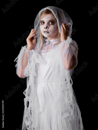 A young girl in a spooky ghost Halloween costume