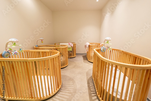 Modern nursery room with wooden baby cribs and soothing decor for infants comfort