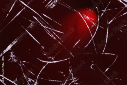 Abstract dark red texture with thin white lines and glowing circular light spot illustration