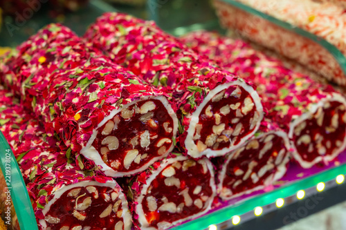 Brightly colored candy rolls filled with nuts and spices