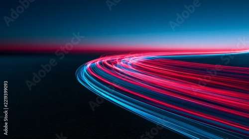 Abstract long exposure photograph of vibrant blue light trails curving sharpl...