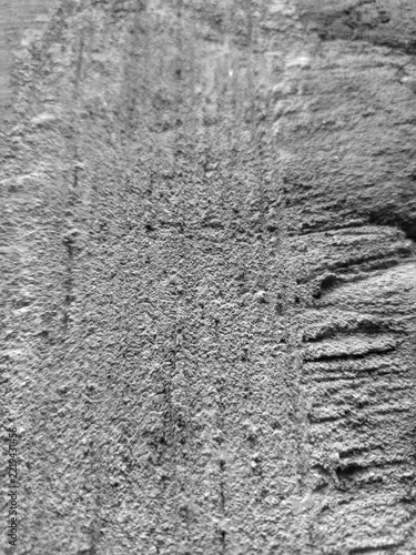 concrete wall texture features a small dark circular hole