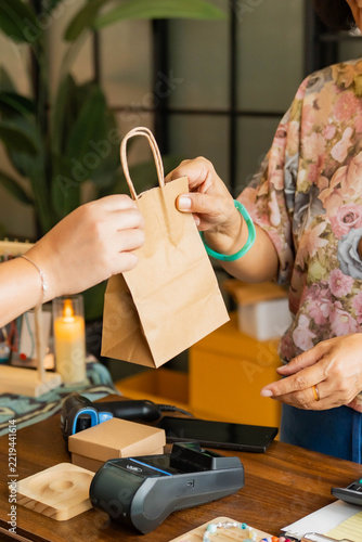 Customer buying handcrafted jewelry at shop