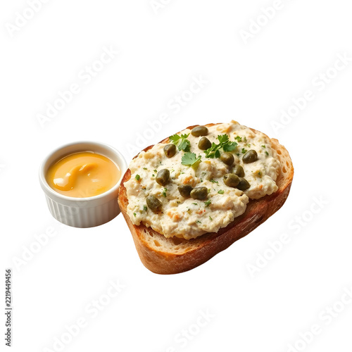 Traditional Belgian filet américain raw minced beef spread with capers and egg yolk isolated on white background.