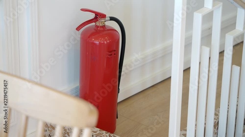 Fire extinguisher placed next to stairs in a building