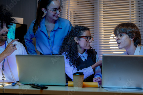 Fotografie Wide shot of a curly-haired developer and a curly-haired engineer react with del